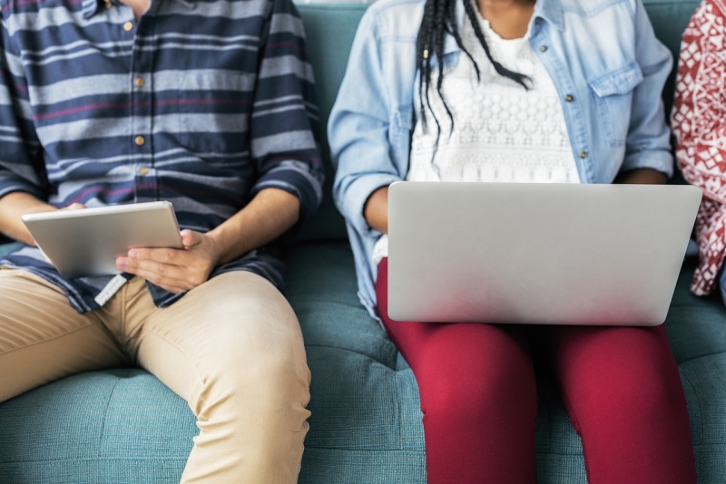 man and woman on a tablet and laptop