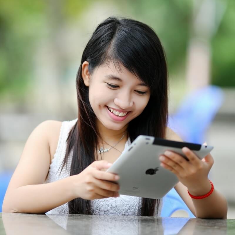 young coin collector using tablet