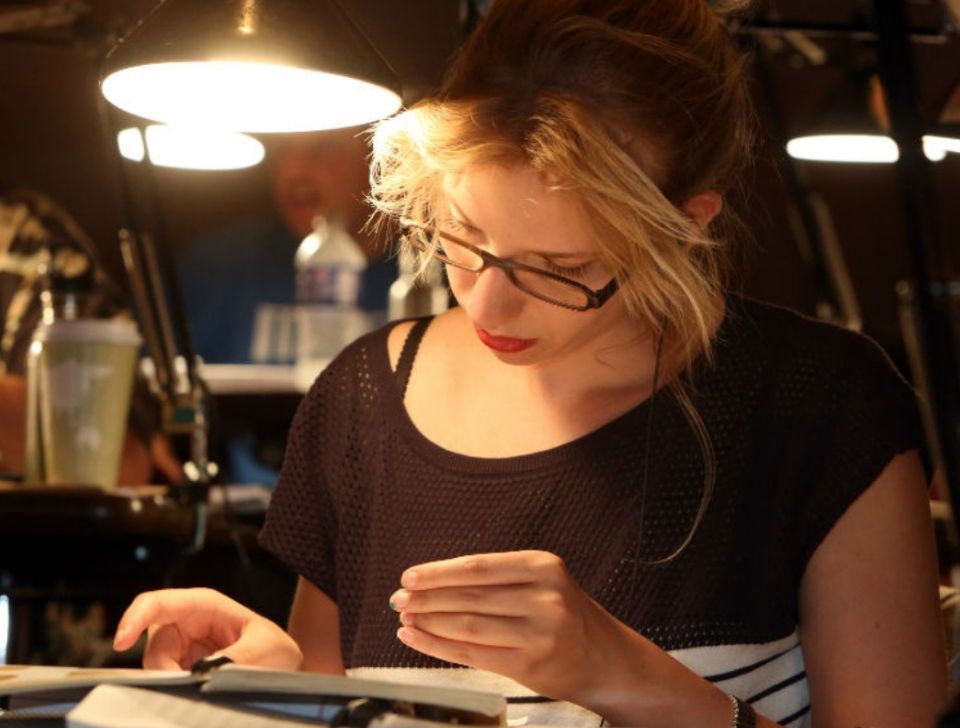 woman studying coin